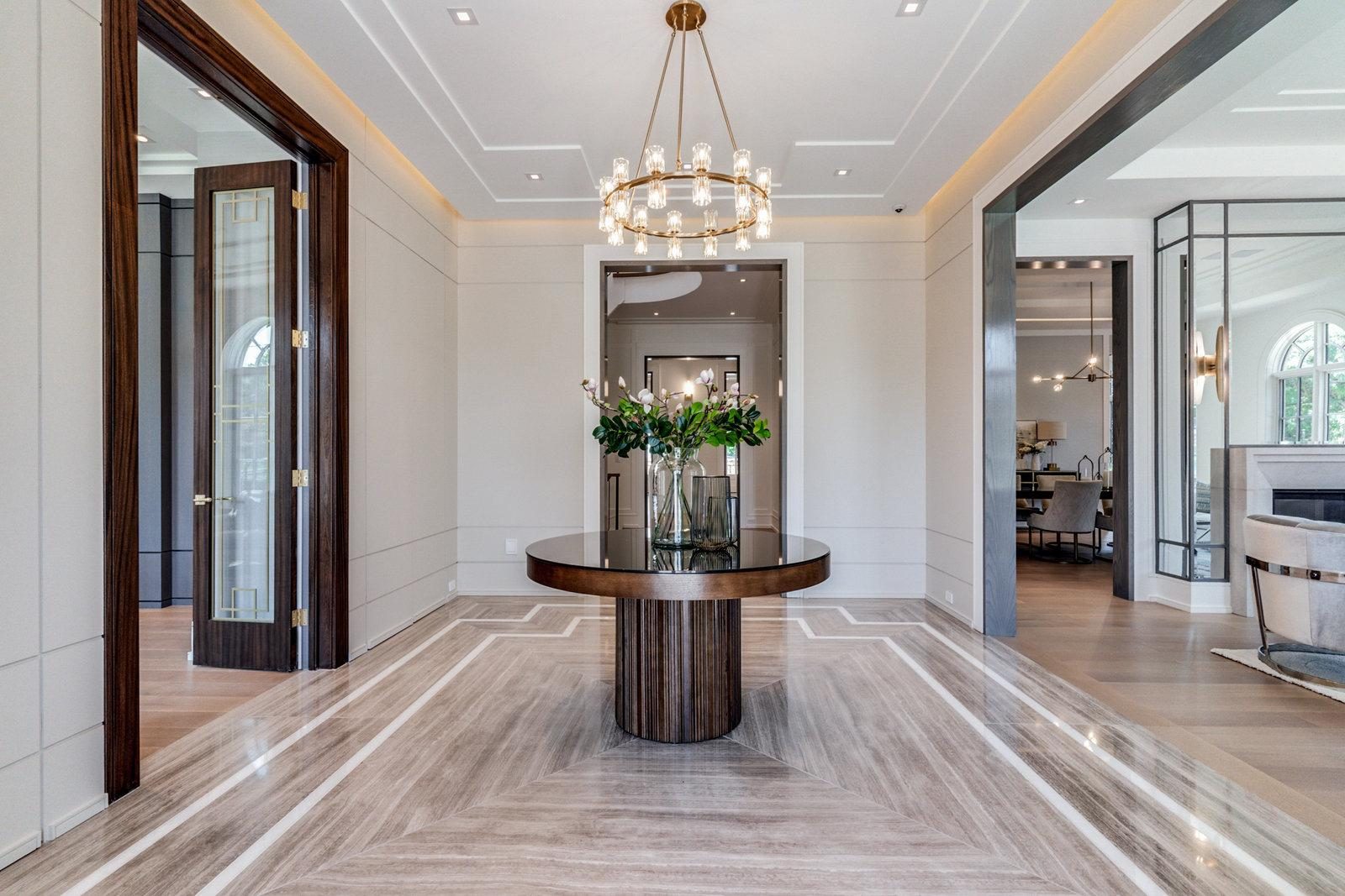 Travertine foyer with curved staircase