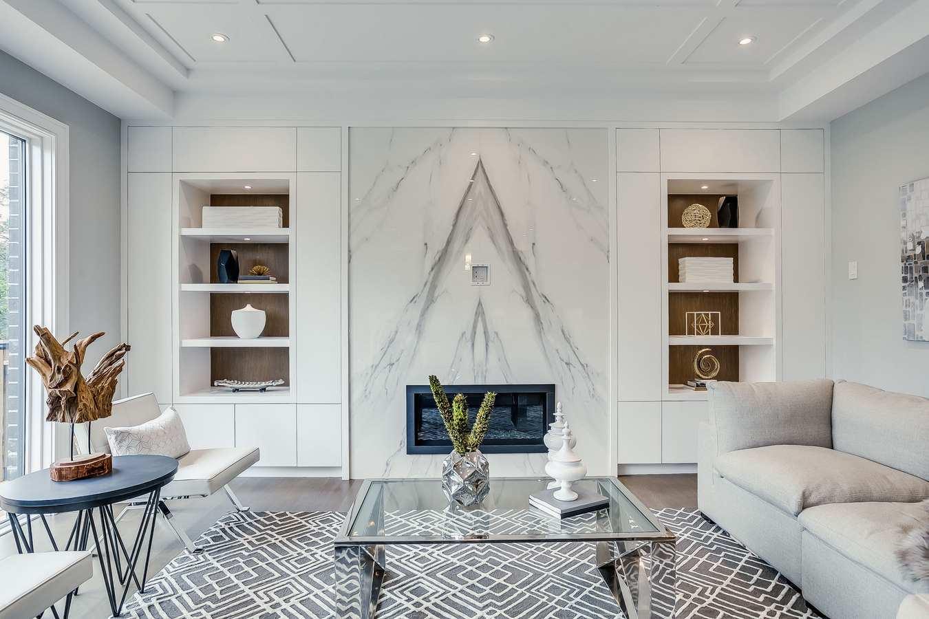 Open concept white kitchen with marble island
